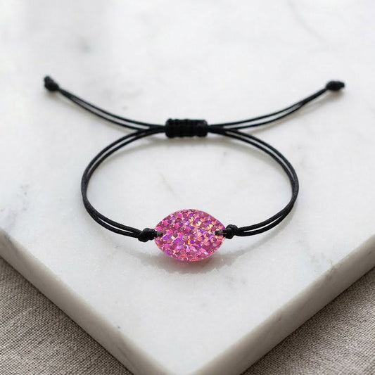 Black cord bracelet with a pink gemstone